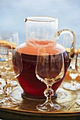A refreshing red drink in a carafe with glass stemware on a tray, Egypt