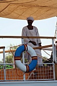 An African passenger at the railing of a Nile ferry, Egypt