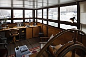 House boat with wooden built-ins in the lounge and a view out of the panoramic windows