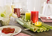 Table decoration on a laid table with coloured candles