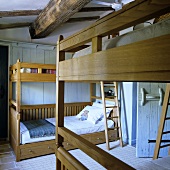 A children's room with honey-coloured bunk beds in a rustic country house
