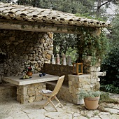 Covered patio area in Mediterranean style out of natural stone