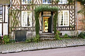 An old half-timbered house with an open front door