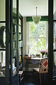 A desk in front of a window in a mini library