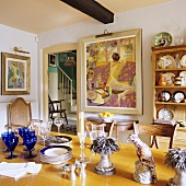 Crockery on a dining table and a view through an open door