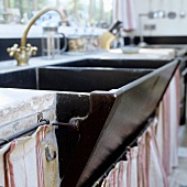 An old double kitchen sink with brass taps