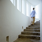 A flight of concrete steps - a man disappearing upstairs