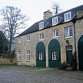 An English country house with a natural stone facade and a deserted courtyard