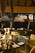 A set table with candlelight on a terrace of a South African home
