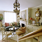 English living room with golden pendulum clock on the wall