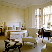 A bedroom in a period building with various types and styles of seats