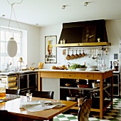 A new country house-style kitchen with a black and white tiled floor