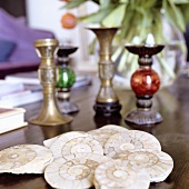 Shells and candle sticks on a wooden shelf