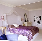 An Oriental bedroom - a light canopy above a shimmering metallic throw