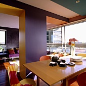 A colourful room - coffee break in an open-plan living room-cum-dining room with a glass wall