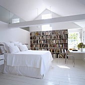 An attic bedroom with a bookshelf and a study corner in a gable