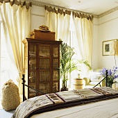 An antique cupboard in a bedroom