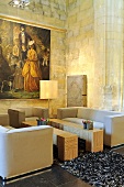 A designer seating area in a renovated church - cubic sofas and a veneered wooden table against a natural stone wall