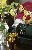 Still life - vases and brass cups on a wooden shelf