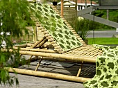 Rattan deck lounger with hand towels