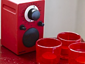 Radio with red cover and tea lights in red glass