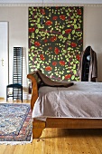 Bedroom with antique wooden bed and wall hanging with floral pattern and chair in Art Nouveau style