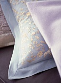 A detail showing delicately embroidered cushion