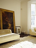 Sitting room with neutral tones and large painting