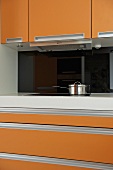 Modern kitchen with orange units