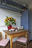 Pendant light above wooden table in country style kitchen