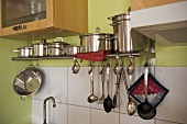 Cooking saucepans on steel shelf