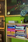 Collection of portrait paintings above book shelf