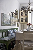 Country style dining room with green bench and wooden table