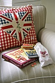 Cushions with Union Jack motifs on upholstered armchair
