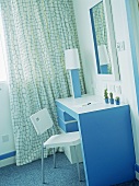 Hotel bedroom with retro styled blue and white dressing table