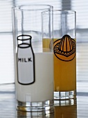 Glasses filled with milk and orange juice