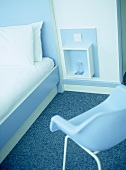 Hotel bedroom with blue and white retro style furniture.