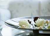 A detail of rose buds in a ceramic dish