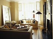 Pair of upholstered sofas facing each other over coffee table in front of fireplace