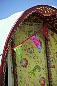 A circus caravan decorated with bunting