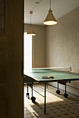 A pendent lamp above a table tennis table