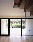 A terrace window with a door and view of a garden