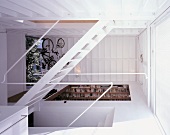 A newly built house with an open stairway and a view into various rooms