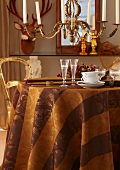 An autumnal table laid with champagne flutes and cups