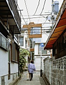 A woman walking down a street in a town