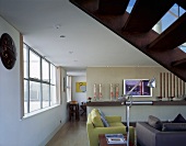 An open staircase with a view underneath into a living room with a sofa