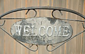 A metal WELCOME sign