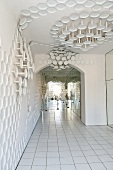An entrance area with white floor tiles and porcelain wall decoration in the Rosenthal Casino, Selb