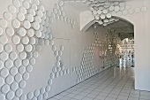 An entrance way with white floor tiles and porcelain wall decorations in the Rosenthal Casino, Selb