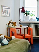 A table and small chairs in a child's room